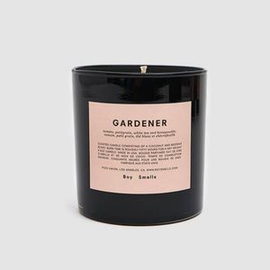 Boy Smells Scented Candle In Gardener